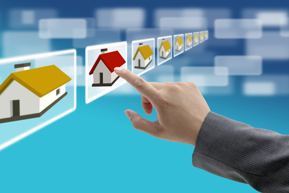 man hand Finding new property in real estate market with electronic commerce concept